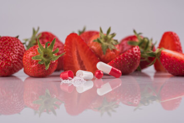 strawberries on a table with pill