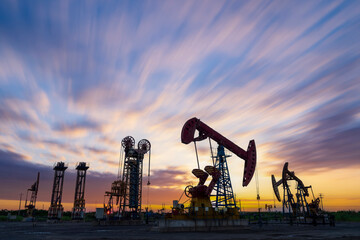 In the evening, oil pumps are running, Silhouette of beam pumping unit