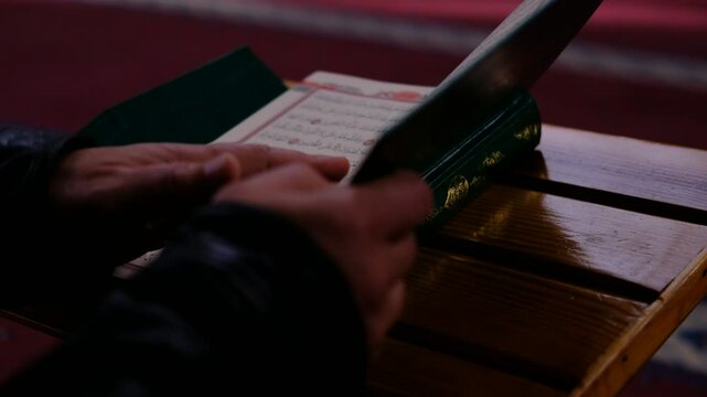 green quran with opened cover