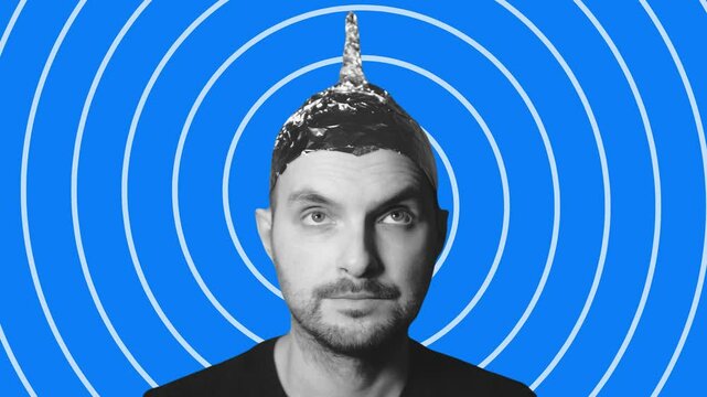 Man wearing tin foil hat on blue concentric circles background