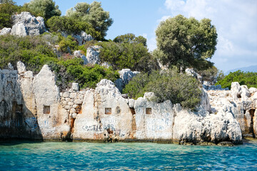Sunken Lycian town view on Kekova island near Kas, Antalya district, Turkiye. The Kekova region is steeped in history, with ruins of ancient settlements around every corner. The turquoise water 