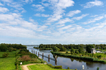 Fototapeta premium High level view over tranquil water of Steenbergsche Vliet near De Heen, the Netherlands near Benedensas lock complex with view towards water of the Volkerak 