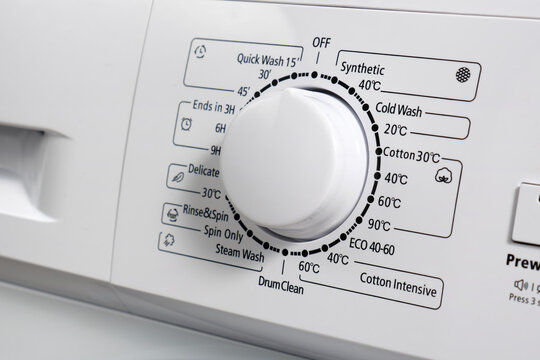 Close-up of the control panel of a modern washing machine gray color. Circle selector for choosing the washing mode.