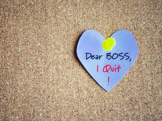Dear boss i quit text written on paper with heart shaped background. Stock photo.