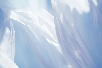 Obraz premium Abstract image of flowing white fabric against a light blue sky, conveying serenity and lightness.