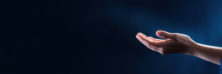 A single human hand is extended against a dark backdrop, implying a gesture of seeking or receiving.