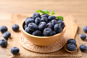 Blueberries in wooden bowl on wooden table, Healthy fruit, Food ingredient
