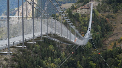 The Andorra Tibetan Bridge, known as Pont Tibet&agrave; Canillo, stretches high above a deep valley, offering stunning views of the surrounding mountains and landscape.

