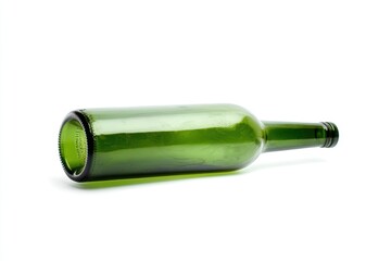 Empty green glass bottle lying on white background, studio shot, recycling concept
