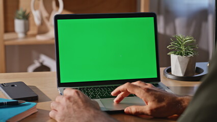 Businessman fingers scrolling mockup laptop touchpad working at cabinet closeup