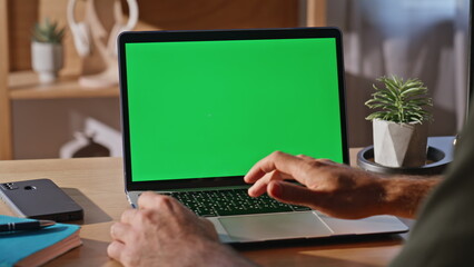 Guy using touchpad chromakey laptop at desk closeup. Businessman surfing online