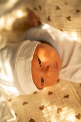 there is a baby that is laying down on a blanket