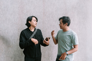 A man gestures while discussing something on a mobile phone,