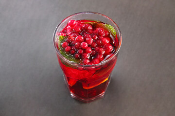 Berry cranberry tea with mint in a glass glass