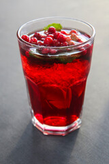 Berry cranberry tea with mint in a glass glass