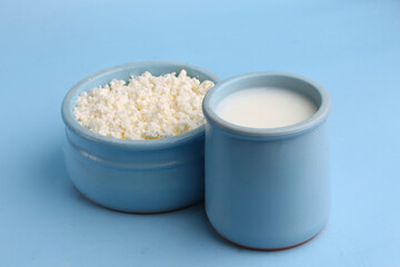 glass of milk and cottage cheese on a blue background