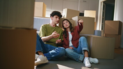Property owners pair inspecting living room after moving relocation at new house