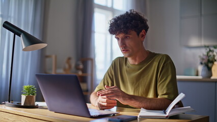 Startuper guy talking online meeting laptop closeup. Serious man video calling