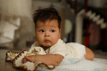 Fototapeta premium a baby laying on the floor with a stuffed animal