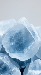 Unique blue crystal formations reflecting light, showcasing intricate textures and natural beauty in a minimalistic setting