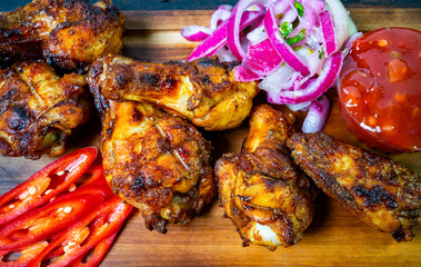 Delicious grilled chicken wings served with fresh vegetables and sauce