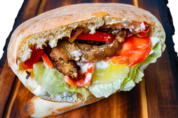 Delicious sandwich filled with grilled meat and fresh vegetables