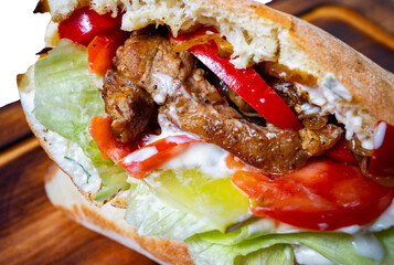 Delicious sandwich filled with grilled meat and fresh vegetables