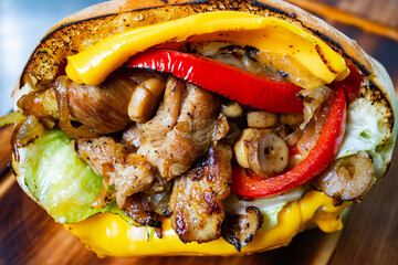 Delicious sandwich loaded with grilled meat and fresh vegetables