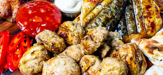 Food platter with grilled meats and sauces served for sharing