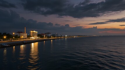 Obraz premium Serene waterfront at twilight with city lights reflecting on calm waters.