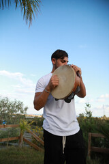Skilled Tambourine Player in Vast Countryside