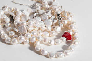 Pearl threads or necklaces on white background. Various natural pearl beads. Handmade necklace