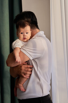 a man holding a baby in his arms