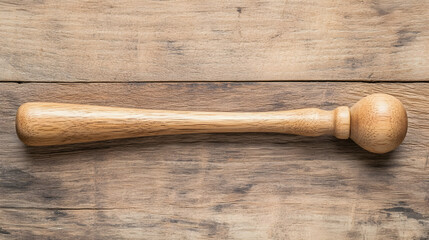 Wooden muddler on rustic wood table, top view, kitchen utensil, cocktail making