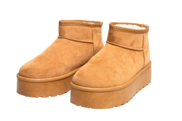 Pair of camel suede boots with platform sole and fur, isolated on transparent background