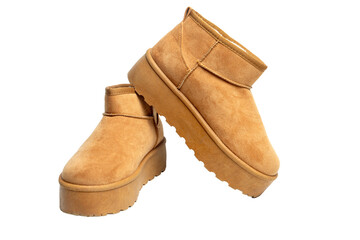Pair of camel suede winter boots with platform sole and transparent background