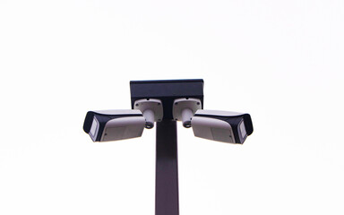 Closed-circuit camera, small CCTV on white bright sunlight sky background. Record events such as traffic accidents. Also prevent thief. Modern technology is widely. Safety protection.	