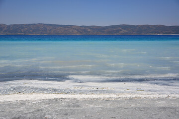 Stunning Salt Lake Landscape with mountain ridge and clear sky 