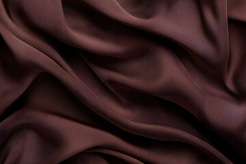 Fototapeta premium Luxurious chocolate brown silk fabric, elegantly draped and flowing, creating soft, sensual waves and folds. Perfect for design backgrounds.