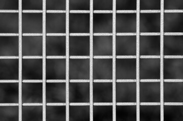 metal grille on grey background close up