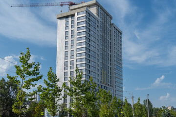 Fototapeta premium New multistorey skyscrapers in business district. Architectural details of luxury house and home complex. Fragment contemporary residential condominium. Geometry modern of apartment building exterior.
