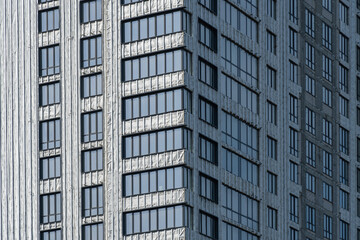 New multistorey skyscrapers in business district. Architectural details of luxury house and home complex. Fragment contemporary residential condominium. Geometry modern of apartment building exterior.