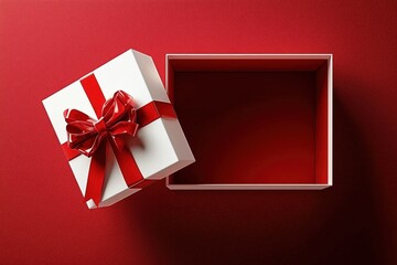 Red gift box with ribbon on red background.