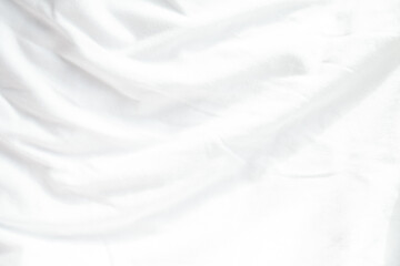 Soft, white fabric with subtle folds and wrinkles.  Perfect for background textures or minimalist designs.