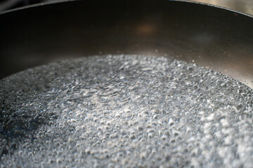 Close-up of boiling water in a pot.