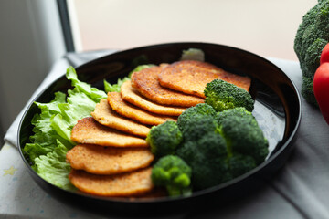 Delicious fried fritters served with fresh broccoli and lettuce. A healthy and visually appealing...