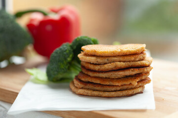 Stack of savory pancakes with fresh vegetables. A healthy and delicious meal or snack.