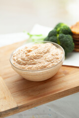Creamy dip served in a glass bowl, accompanied by fresh broccoli florets. Perfect for healthy snacking or as a side dish.