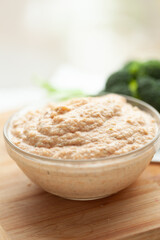 Creamy textured dip in a glass bowl, ready to serve. Perfect for various dishes or as a snack.