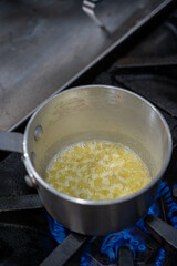Melting butter on a stovetop in the kitchen